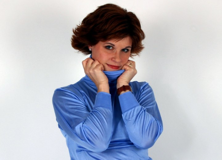 Woman who is playing with the collar of her silk turtleneck