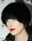 Agyness Deyn with short black hair that covers her ears