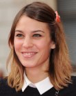Alexa Chung wearing her hair in a simple style with an off center part