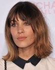 Alexa Chung with her hair cut into a long bob with layers and bangs