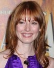Alicia Witt wearing her red hair long and with below the eyebrows bangs