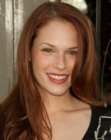 Amanda Righetti wearing her red hair with a high part and draping down her shoulders