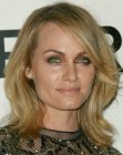 Amber Valletta wearing shoulder length hair with wavy styling for volume