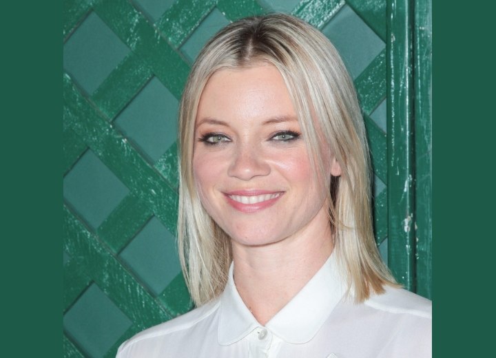 Amy Smart wearing a bob haircut and a blouse with buttoned-up collar