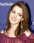 Anne Hathaway with her long hair styled for a hippie look
