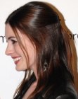 Anne Hathaway's sleek long hairstyle with the top styled towards the back
