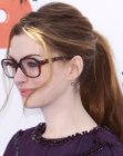 Anne Hathaway with her hair secured in a thick ponytail