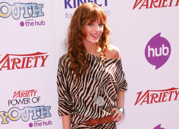Bella Thorne wearing a zebra print dress and leather boots