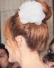 Bella Thorne's ballerina hairstyle with a flower accessory