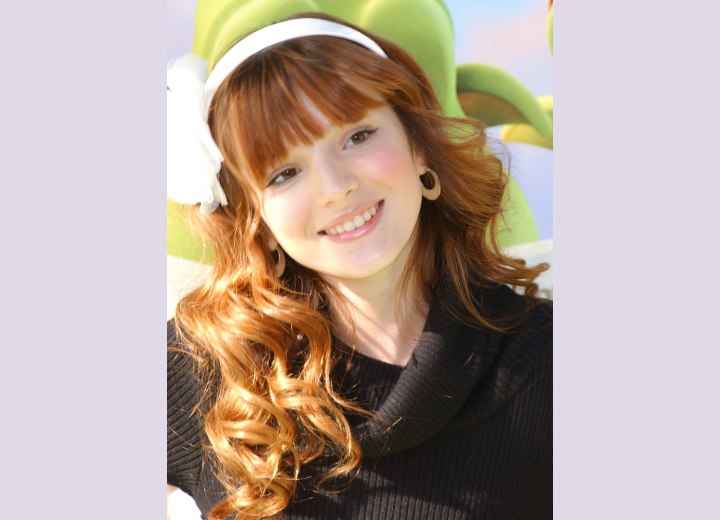 Bella Thorne with long red hair and a hair band