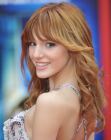 Bella Thorne's long hairstyle with bangs and spiral curls