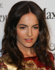 Camilla Belle's long hairstyle with a middle part and loose curls
