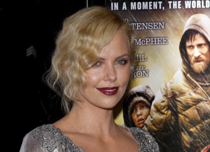 Charlize Theron wearing her hair up and styled with waves