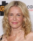 Chelsea Handler wearing her hair in a shoulder length style with curls and waves