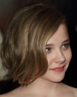 Chloe Moretz sporting a short bob with one side pulled behind the ear