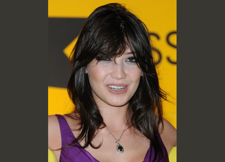 Daisy Lowe wearing her brown hair in a long shag