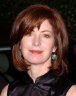 Dana Delany sporting a medium long layered hairstyle with a tapered fringe