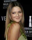 Drew Barrymore sporting sleek long hair with a flattering color