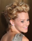 Elizabeth Banks with her curly hair brought up