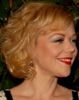 Emily Bergl's mid-neck hairstyle with styling for volume