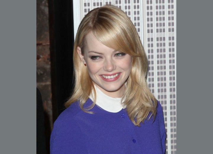 Emma Stone sporting a long hairstyle with a curved fringe