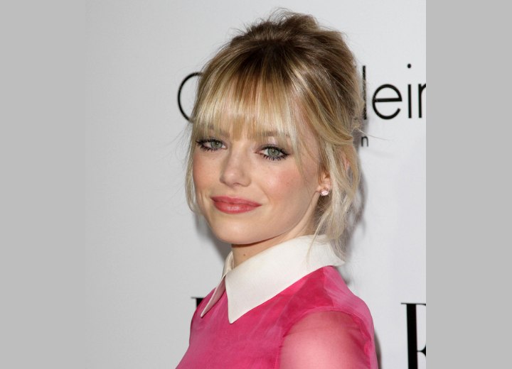 Emma Stone wearing her hair in a loosely styled updo