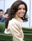 Eva Longoria with her middle of the back hair styled into bouncing curls