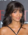 Halle Berry with her long hair pulled away from her face and fastened in the back