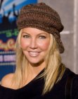 Heather Locklear sporting long sleek hair and wearing a knitted hat