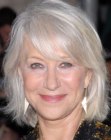 Helen Mirren with her silver white hair cut into a medium length style