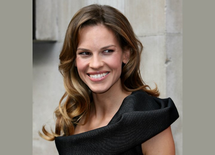 Hilary Swank with her long hair styled to curls