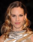 Hilary Swank sporting long hair with large curls