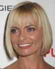 Jaime Pressly sporting an under the chin bob with long wispy bangs