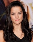 Jaimie Alexander wearing her long thick hair in a simple style with curls