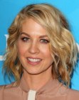 Jenna Elfman sporting a long angled bob with layers and waves