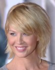 Jenna Elfman with her hair cut in a neck-length shag with side bangs