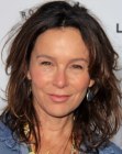 Jennifer Grey wearing her naturally curly hair in a medium length style