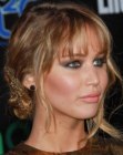Jennifer Lawrence's updo with a woven chignon and long bangs