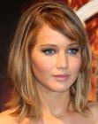 Jennifer Lawrence's medium length hairstyle with height on top of the head