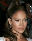 Jennifer Lopez wearing her hair in a curly ponytail
