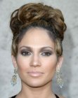 Jennifer Lopez wearing her hair in a high curled updo
