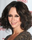 Jennifer Love Hewitt's medium length hairstyle with waves and curls