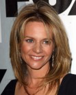 Jessalyn Gilsig's below the shoulders hair with an irregular middle part