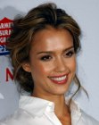 Jessica Alba with her hair twisted into a loose up style