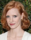 Jessica Chastain with her red hair cut into a medium long bob with curls