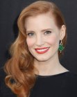 Jessica Chastain with her long curly hair styled over to one side