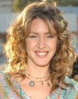 Joely Fisher wearing het hair long with a spiral perm
