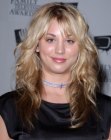Kaley Cuoco wearing her hair long with layers and curls