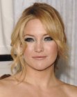Kate Hudson with her hair gathered in a braided ponytail