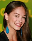 Brunette Kristin Kreuk's long hairstyle with shine and a middle part